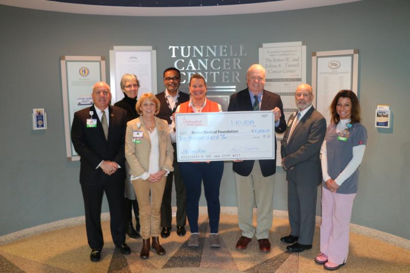 Check presentation attendees shown are (l-r) Tom Protack, Beebe Medical Foundation vice president of development; Diane Barlow, gift planning officer; Judy Aliquo, president and CEO; Derrick Johnson, Tunnell Cancer Center business manager; Anne Raskauskas, event organizer; Ed Burke; Barry Hamp, Beebe Healthcare executive director, oncology services; and Kristen Rahn, Beebe Oncology Services manager of radiation therapy. SUBMITTED PHOTO